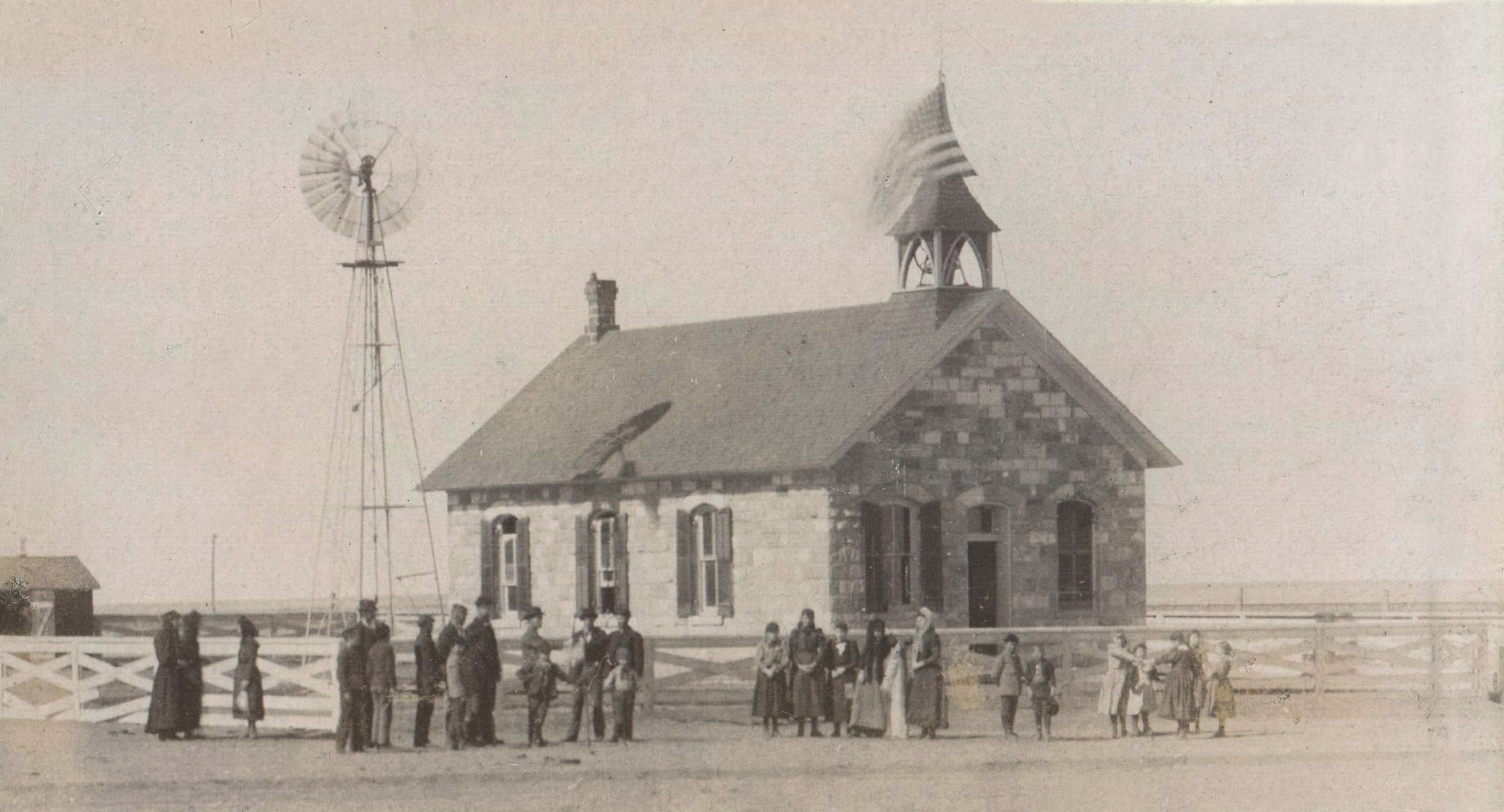 The flag-topped stone Collyer schoolhouse, an example of that, was built in 1885. Trego County Historical Society 