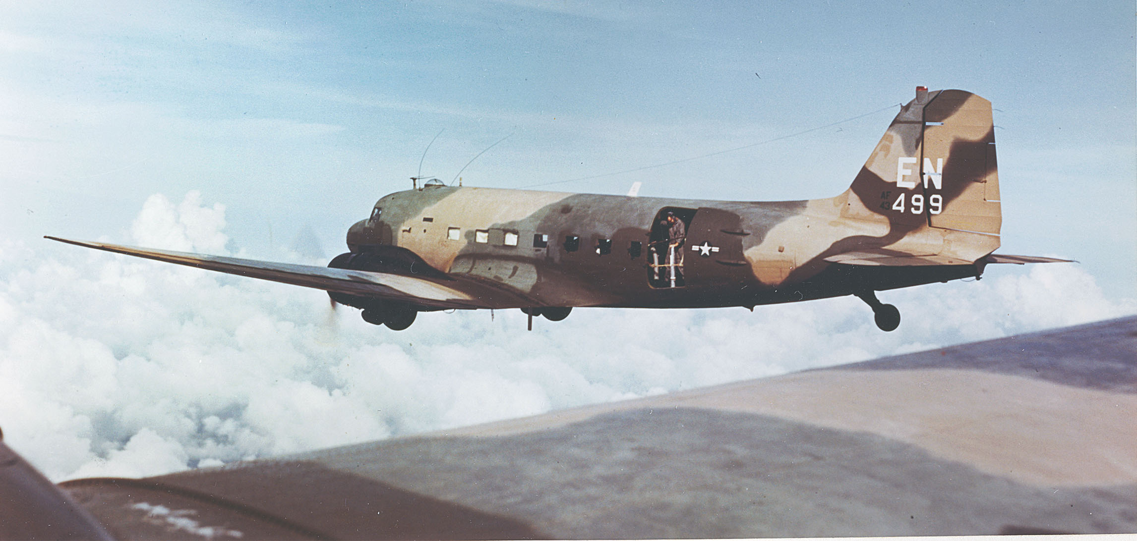 A Spooky gunship of the 4th Air Commando Squadron deploys on another mission. A crewman stands at the rear cargo door of the aircraft, nicknamed “Puff the Magic Dragon.” / U.S. Air Force