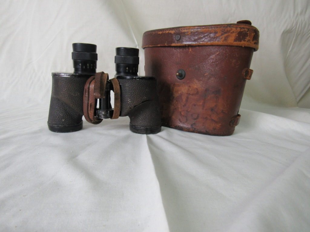 GLIMPSE OF THE PAST: Frank Draper—one of 20 men from tiny Bedford, Virginia, who died on D-Day—carried these binoculars (above) as his landing craft approached Omaha Beach. A German shell struck the craft, and Draper (below) was mortally wounded before he even reached shore. He was taken back to the troopship SS Empire Javelin, where a British sailor tried to render first aid, removing the binoculars from the dying man’s neck in an effort to provide comfort. Draper passed away within minutes; the man who tended to him, Bert Fuller, kept the binoculars for 61 years as a reminder of D-Day before returning them in 2005 to Draper’s family in Bedford.