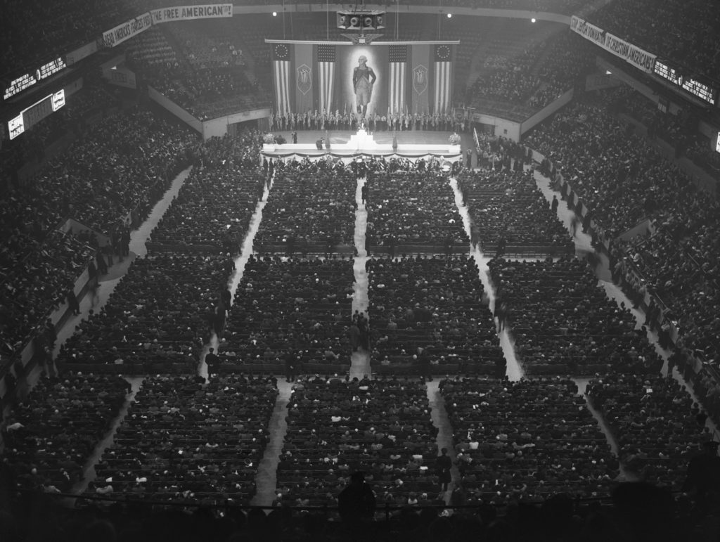 The German American Bund holds  a 22,000-strong rally in 1939 at New  York’s Madison Square Garden. Below, members of the America First Committee march in 1941. (Bettmann/Getty Images)