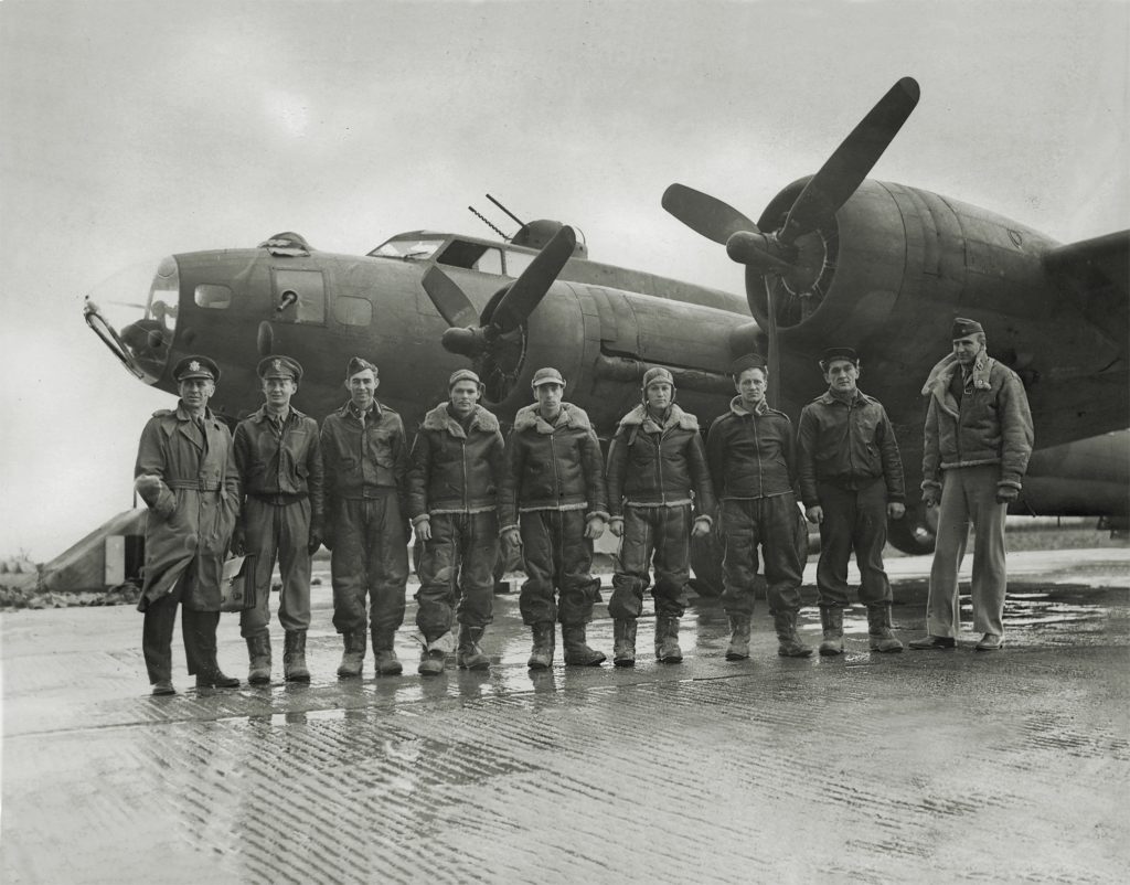 Armstrong (above, far left) took command of the battle-weary 306th Bomb Group in January 1943. After restoring the group to combat readiness, he and this B-17 crew led the first American daytime raid over Germany—a bombing run on the naval base at Wilhelmshaven (below). (IWM FRE 4404)
