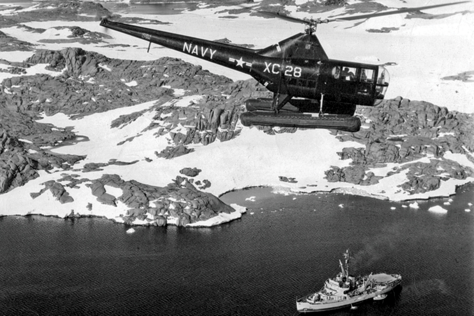 A Navy Sikorsky HO3S-1 helicopter surveys Antarctica’s inhospitable terrain. (National Museum of Naval Aviation)