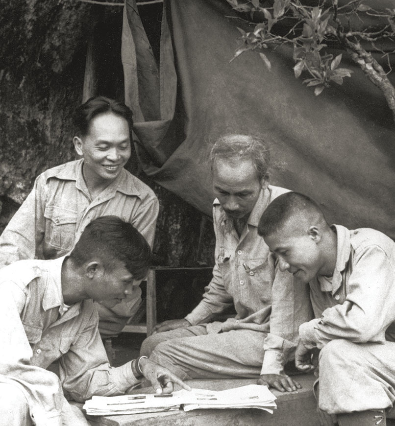Giap, top left, and Ho, center, meet with military leaders in the 1950s. / Getty Images