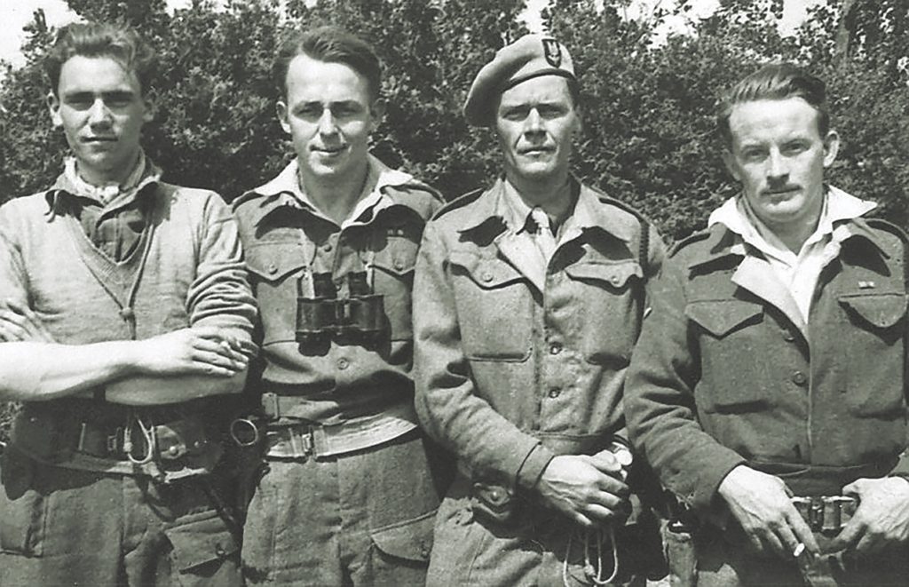 Captain Tonkin and Lieutenant Peter Weaver (left to right, center, top, with two unidentified men) were among the few survivors of a July 3, 1944, German raid. Members of the Resistance (like these hailing British troops, below) were executed on the spot. Captured British troops—along with Bundy—were gunned down the morning of July 7, 1944, and buried in the forest. (Paul Mccue)
