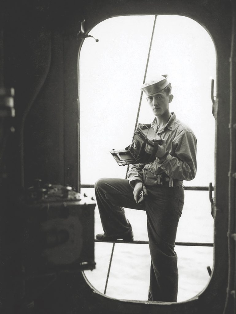 Photographer Herman Schnipper, here in a self-portrait aboard the USS Astoria, documented the day’s mayhem. (Herman Schnipper/U.S. Navy) 