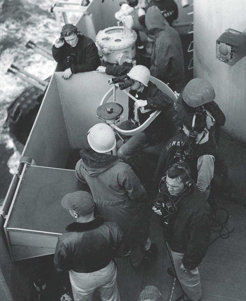 Below Schnipper, sailors man a battle station (above). No enemies were in sight yet, but experience told them they were coming. One defense: the experimental flak suits (below), which the men roundly despised. (Herman Schnipper/U.S. Navy) 