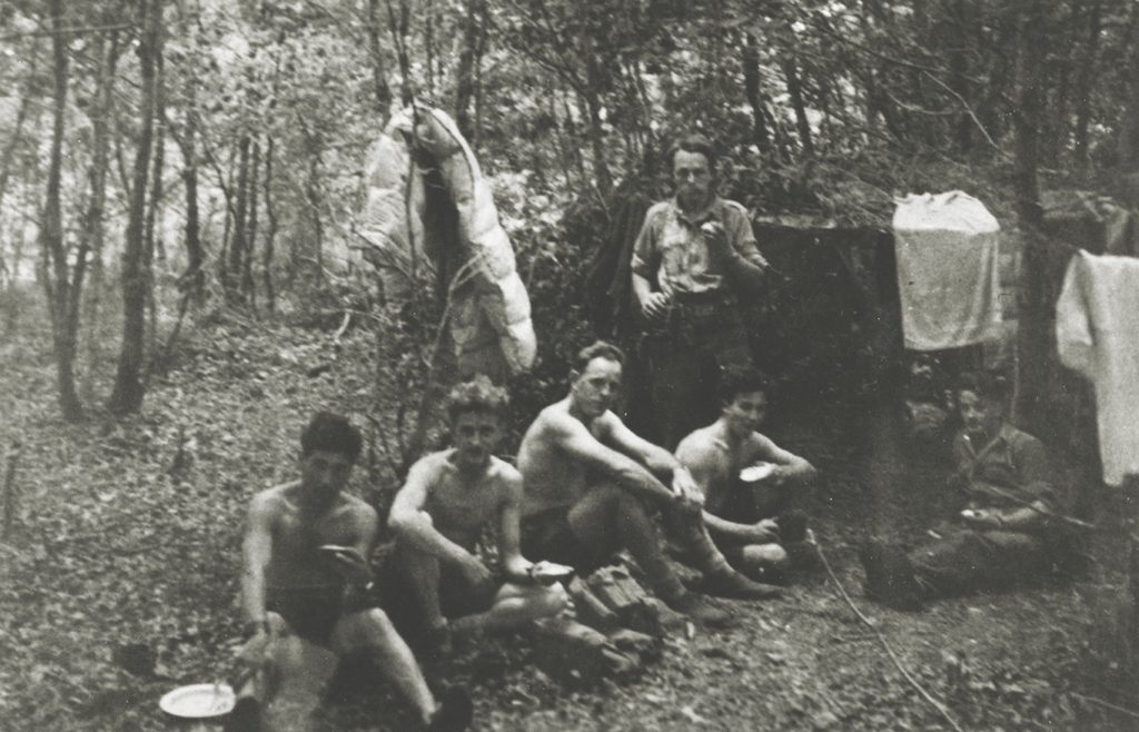 Men of Britain’s Special Air Service (SAS) rest in their French forest hideaway (above); Captain John E. Tonkin is standing. The group was working with French Resistance fighters (below) to prevent the Germans from moving men and materiel north to Normandy. (Roger Viollet via Getty Images)