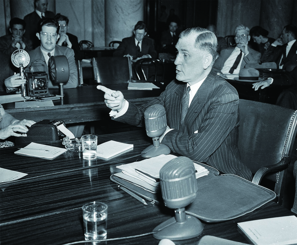 NRA man Milton Reckord, here testifying before a Senate committee on May 5, 1941, decried the idea of fighting criminals by constraining legitimate gun owners. (AP Photo/Henry Griffin)