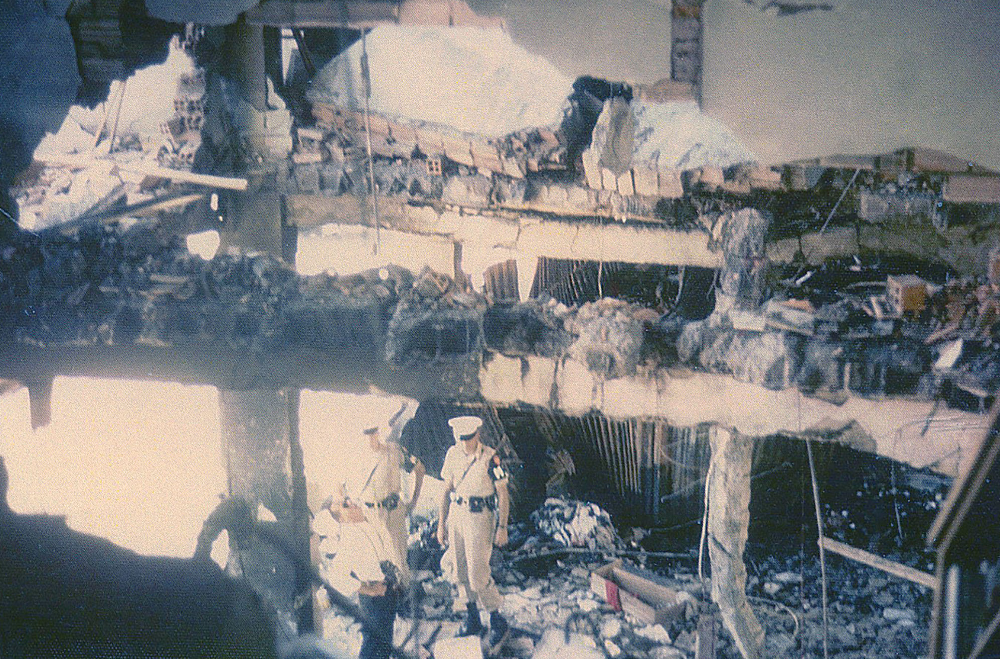 Two MPs and another man inspect the damage in the room next to Reynolds’ quarters. One of the men staying there was a friend of Reynolds and died in her presence at the hospital. / Courtesy Ann Darby Reynolds