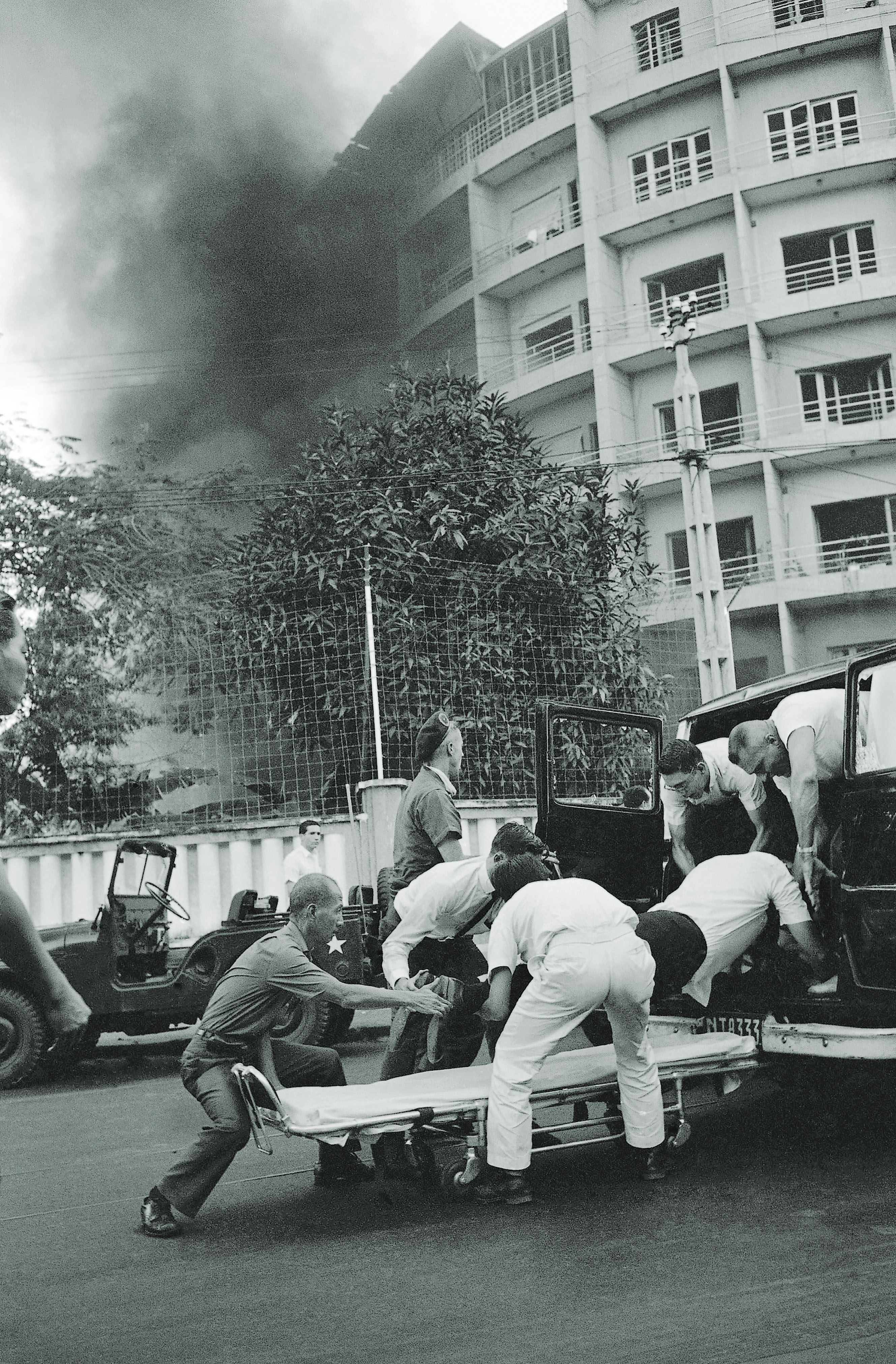 An American officer wounded by a Viet Cong bomb explosion is loaded into an ambulance in front of Saigon’s Brink Hotel, quarters for U.S. officers, on Dec. 24, 1964. / AP