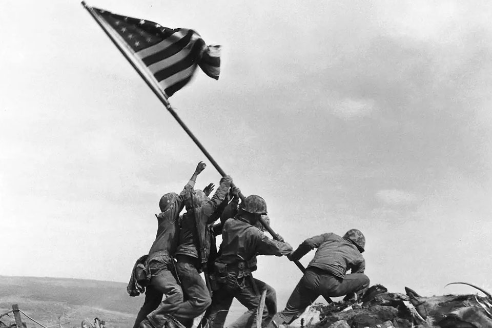 Col. Dave Severance, Company Commander of Easy Company of the 28th Marines, 5th Marine Division, became associated with a historic moment in American history on Feb. 23, 1945, when he responded to orders from his battalion commander to send a patrol to Mount Suribachi, the highest summit on the island described by Marine Lt. Gen. Holland M. “Howlin’ Mad” Smith as a “grim, smoking rock.” Following orders from the battalion commander, the platoon hoisted an American flag on the summit. But it wasn’t the famed image captured by Associated Press photographer Joe Rosenthal. The Secretary of the Navy James V. Forrestal, upon seeing the first flag raised on Mount Suribachi, wanted to keep it as a memento. Thus a second larger flag was raised to replace it, which Rosenthal went on to document to much acclaim. (USMC)
