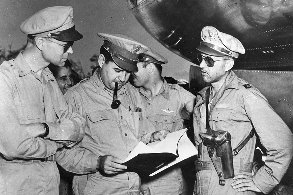 Brig. Gen. Thomas Power (right) reports to Maj. Gen. LeMay (center) on the results of the Tokyo firebombing raid he led on March 9-10, 1945. (Air Force Association)