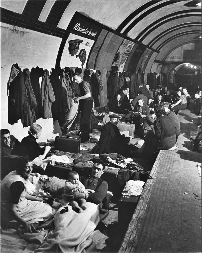 Taking refuge from bombs, civilians huddle in an underground shelter in London's West End. / U.S. National Archives 