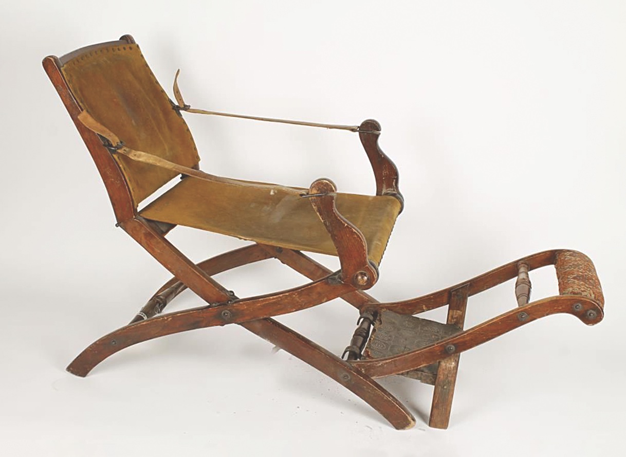 This antique wooden chair, with suede seat and back, was used in the Civil War era both as a barber chair and for treating dental patients. It remains in full working condition. (Reata Pass Auctions)