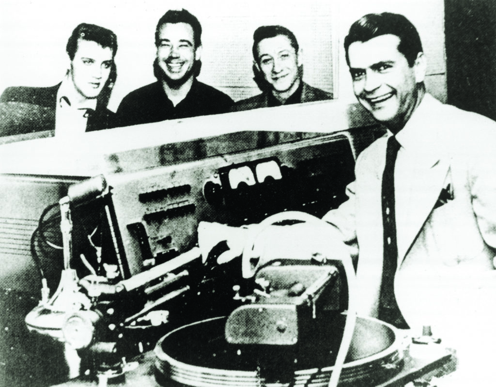 Elvis Presley, Bill Black, and Scotty Moore at Sun Records with owner/producer Sam Phillips. 