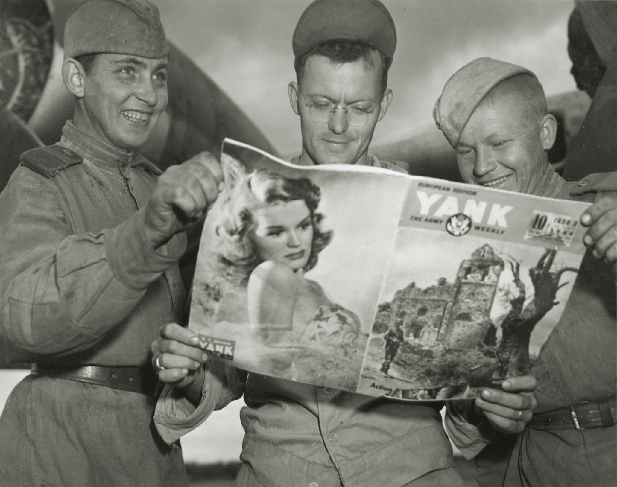 Shared copies of Yank were popular with Allied service members, though their obvious enthusiasm may have landed these flanking Russian soldiers in hot water. / National Archives
