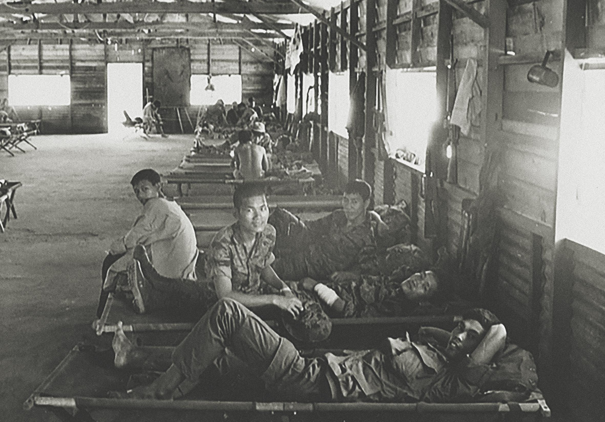Nung soldiers, South Vietnamese of Chinese descent, who fought at Ngok Tavak in the 11th Mobile Strike Force Company, receive treatment for their wounds after being evacuated. / AWM P11058.003