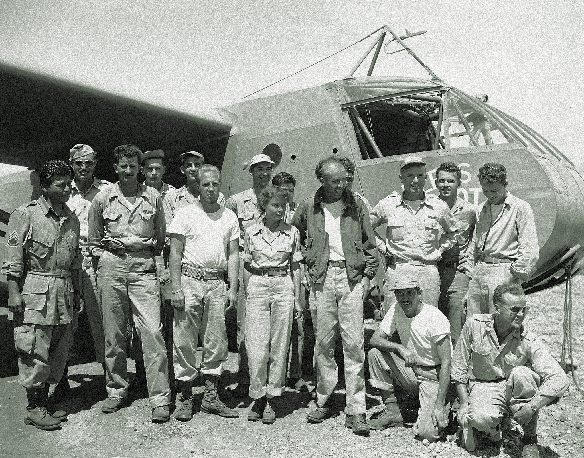 McCollom, Hastings and Decker (at center from left) and members of the rescue team pose for a group photo in front of the Waco CG-4A glider. / Frank Filan, Associated Press