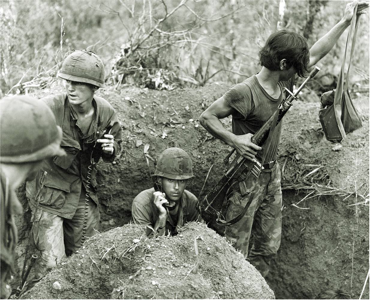 Delta Company Capt. Leland Roy calls in artillery fire and air support. With him are two of his soldiers and a Vietnamese guide. / Casemate Publishers