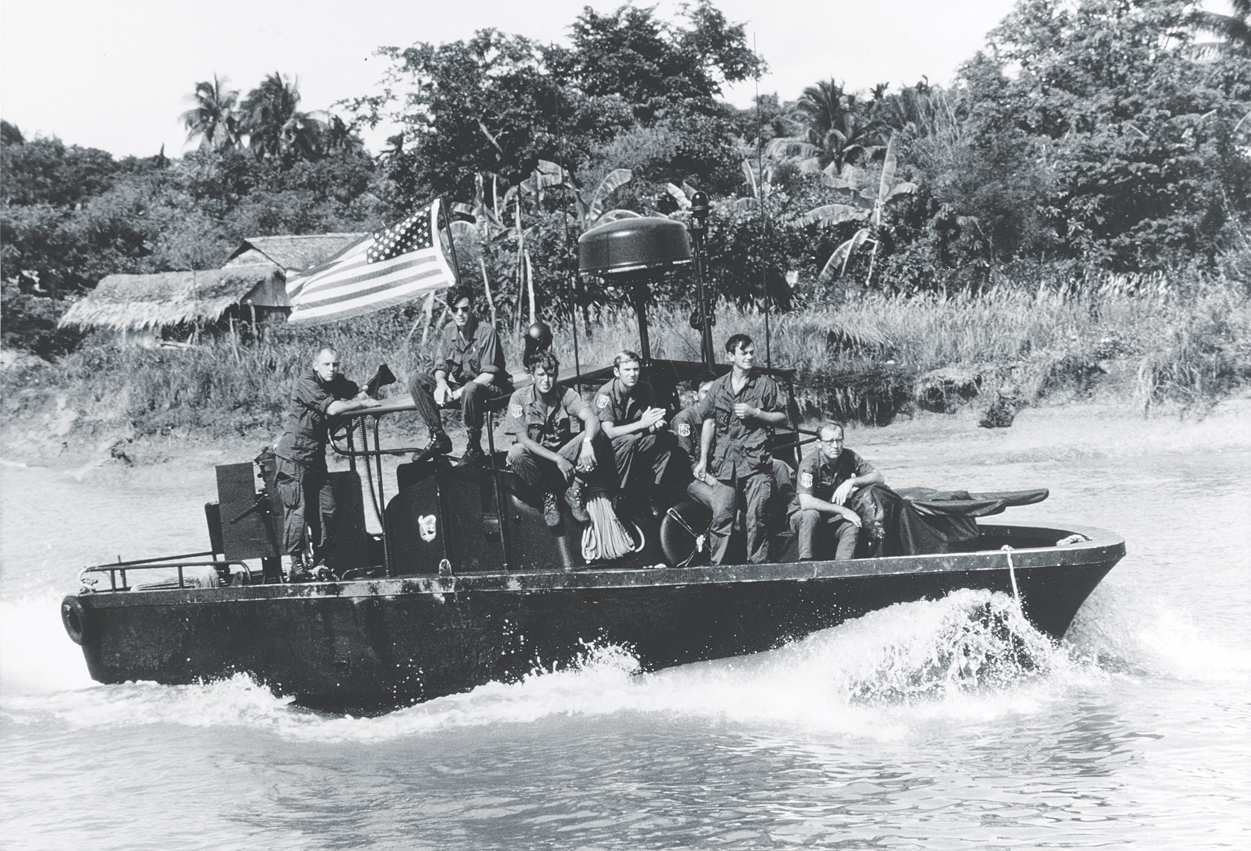The crewmen of a PBR appear relaxed during a patrol run along the My Tho River in June 1969. / Naval History & Heritage Command