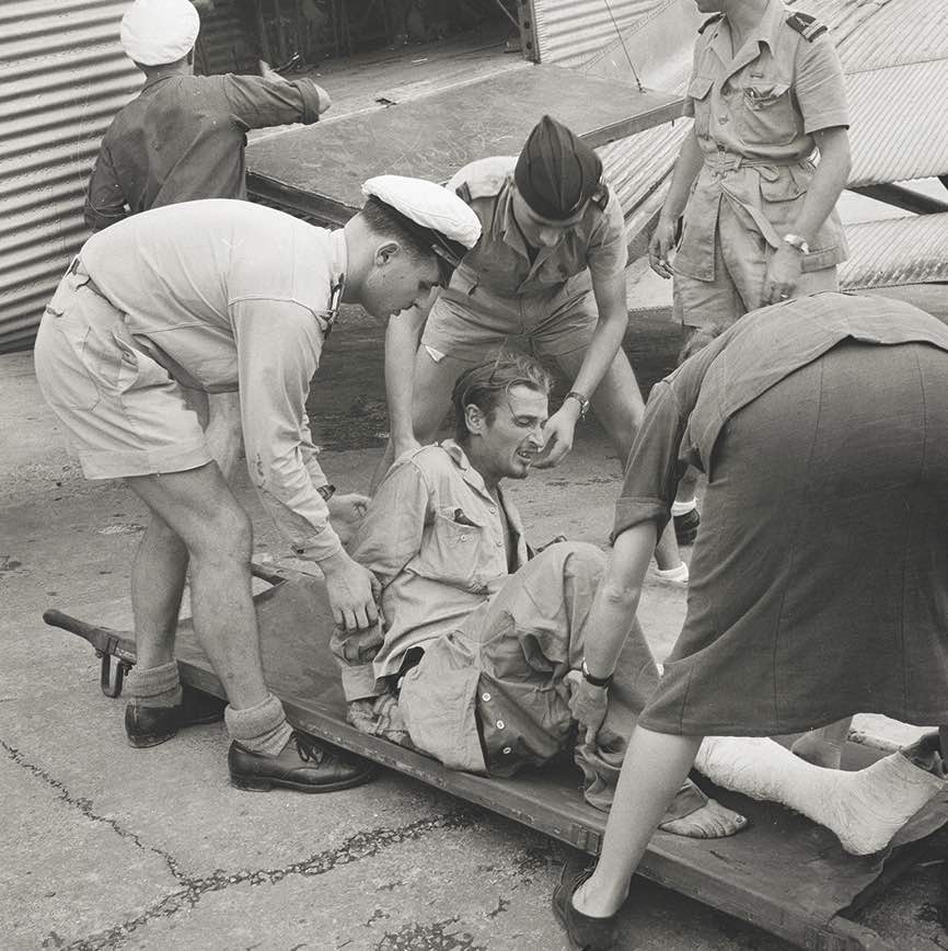 A wounded French soldier is placed on a stretcher after evacuation from Viet Minh-held That Khe in November 1950 during a truce. / Bettman/Getty Images
