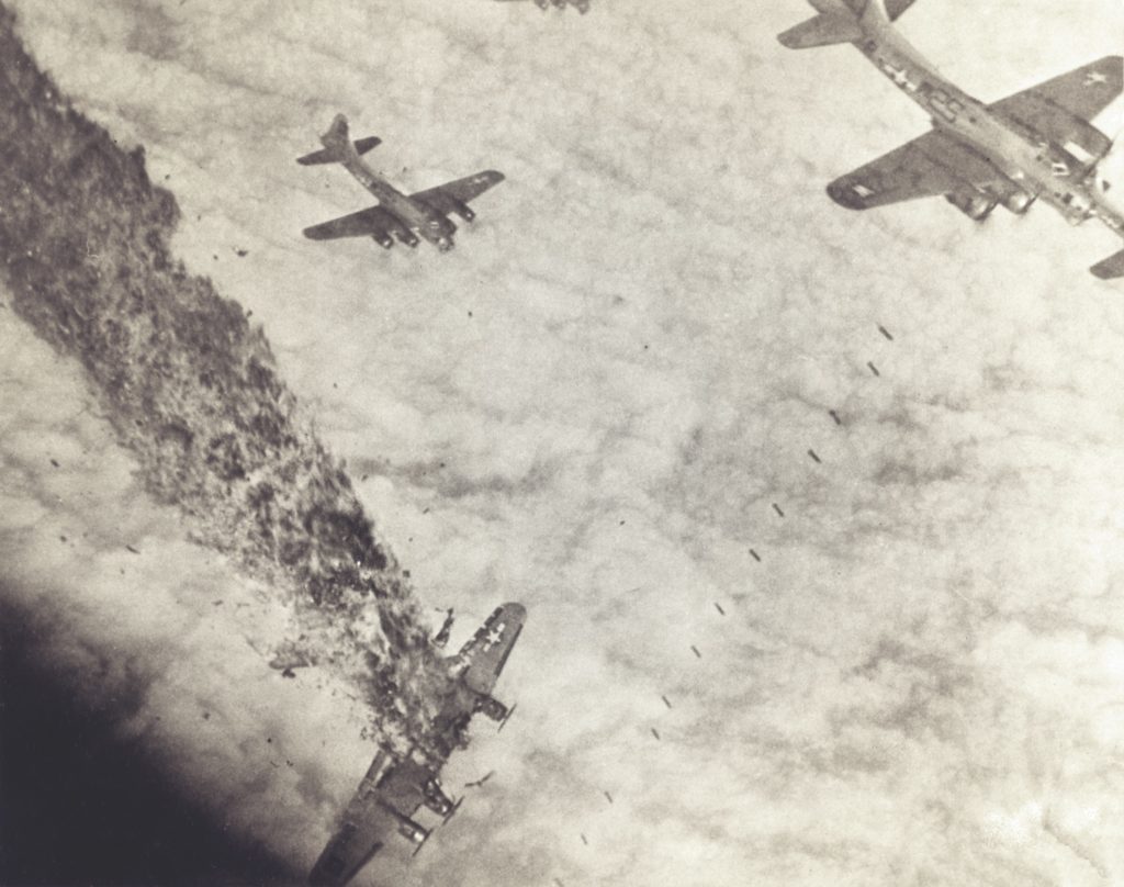 Struck by enemy fire, a crippled B-17 of the Eighth Air Force lists downward amid a 1944 bombing raid on Merseburg, Germany. (U.S. Air Force/National Archives)