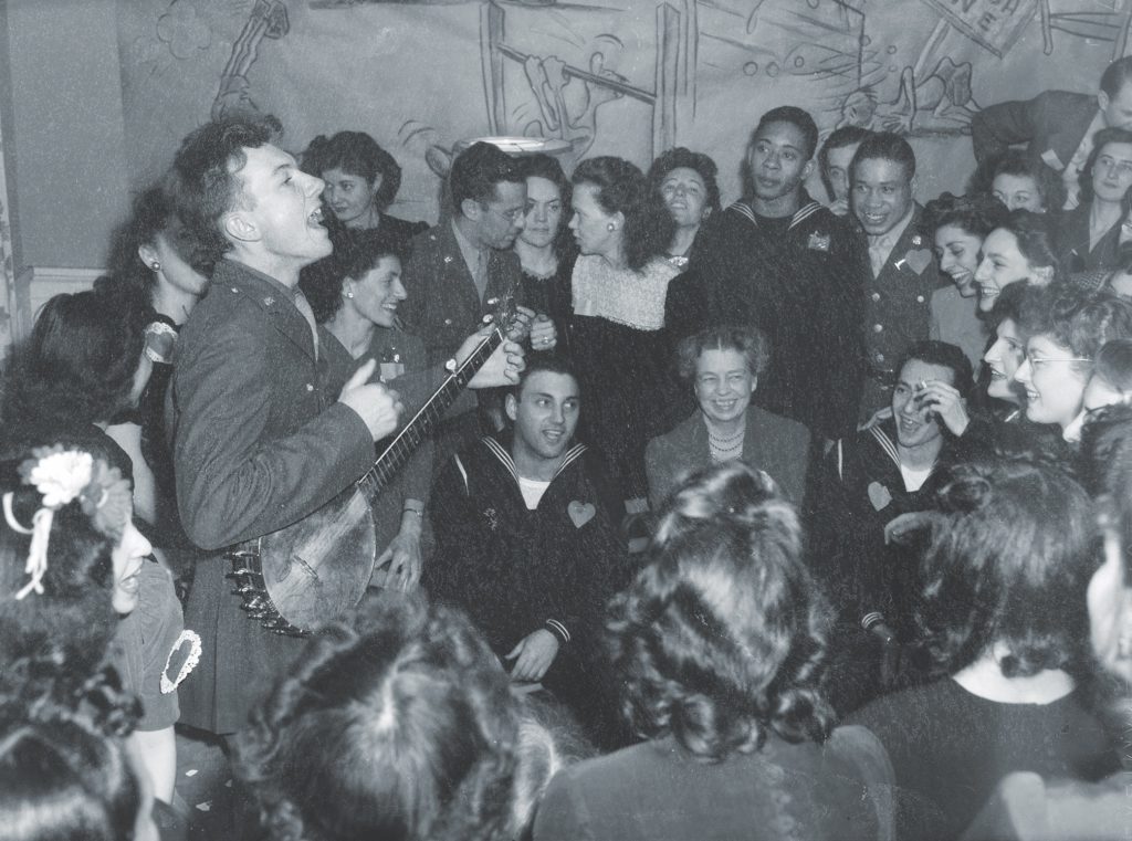 Folksinger Pete Seeger leads the crowd in “When We March into Berlin” in 1944. Music helped fill the void, he said, when “there is not much else to do.” (Joseph A. Horne/Office of War Information/Library of Congress)