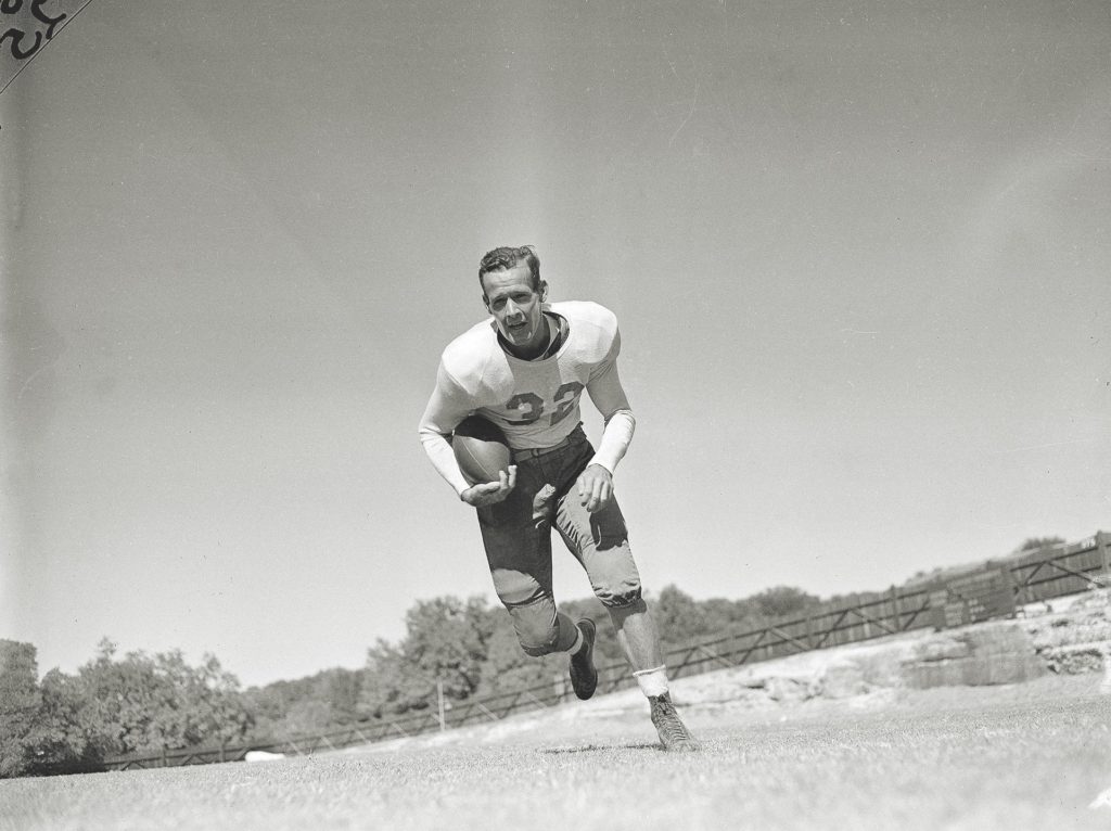 Landry resumed football after the warâ€™s end, playing fullback for the University of Texas-Austin (top) and joining the New York Giants (below) as a defensive back in 1950. (AP Photo/Carl E. Linde)