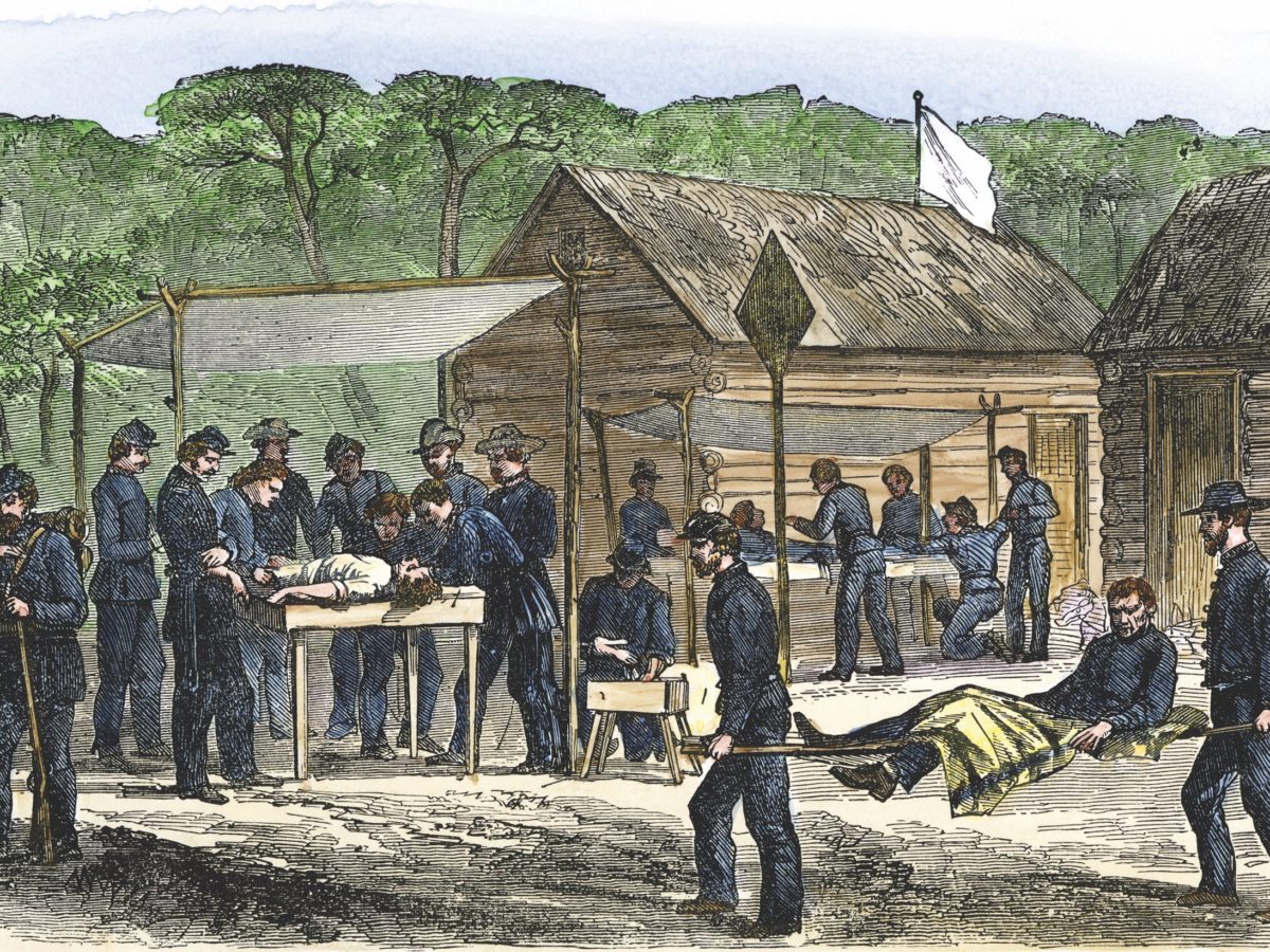 Litter bearers bringing wounded men to a Union field hospital after a Civil War battle in Virginia 1863.