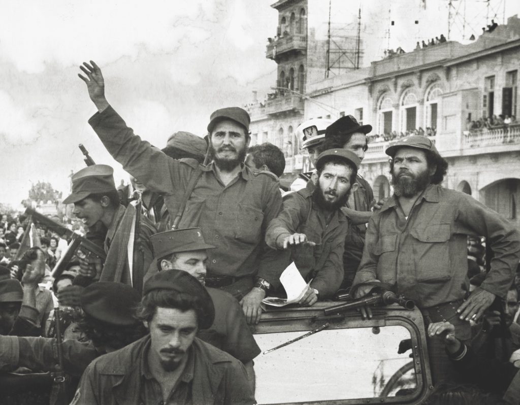 Castro and his revolutionaries greet jubilant crowds as they arrive in the capital city of Havana on January 8, 1959