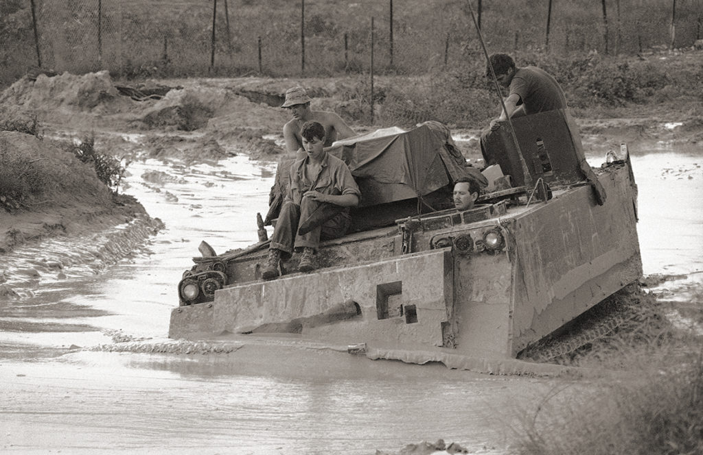 An armored personnel carrier of 2nd squad, 11th armored cavalry plows through monsoon mud at firebase warrior 25 miles northwest of Saigon in Vietnam on Sept. 18, 1971. The cavalry conducts defensive operations and monitors enemy infiltration routes from Cambodia to Saigon. (AP Photo)