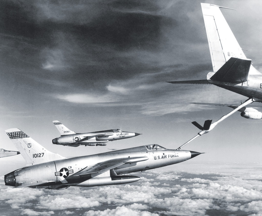 Three Air Force F-105 Thunderchief pilots enroute to bomb military target in Vietnam pull up to a flying Air Force "gas station."  The refueling aircraft is an Air Force KC-135 Stratotanker.  January 1966. (National Archives) U.S. Air Force Republic F-105D Thunderchief fighters refuel from a Boeing KC-135A Stratotanker en route to North Vietnam in 1966.  The aircraft were from the 334th Tactical Fighter Squadron, deployed from the 4th Tactical Fighter Wing at Seymour Johnson AFB, North Carolina (USA) to Takli RTAFB.