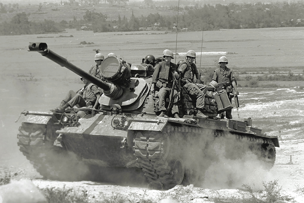 Marines ride an M48A3 Patton tank to their next destination in 1966. 