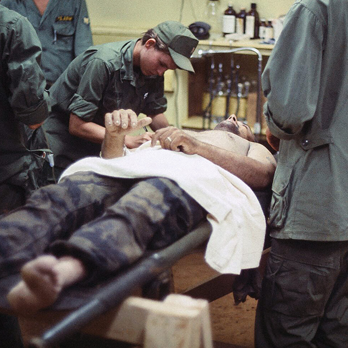 A nurse helps prepare a patient for an operation at the 7th Surgical Hospital, a mobile army surgical hospital (MASH), at Blackhorse base camp near Saigon in 1968. Nurses were among the earliest U.S. service members to arrive in Vietnam.