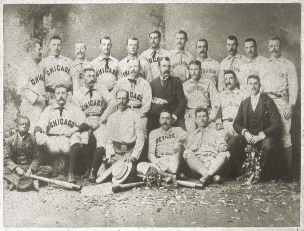 MELBOURNE, AUSTRALIA - 1889: The Around the World baseball tourists from the United States pose in a photo studio in Melbourne, Australia for a group portrait in 1889.  The group was composed of the Chicago White Stockings, including Cap Anson, seated middle row, third from left, Ned Williamson, seated middle row, far left, and a team of National League All-Stars, including Ned Hanlon, front row, middle and John Ward, middle row third from right.  The organizer of the tour, Al Spalding, sits in the middle row fourth from right.   (Photo by Mark Rucker/Transcendental Graphics/Getty Images)