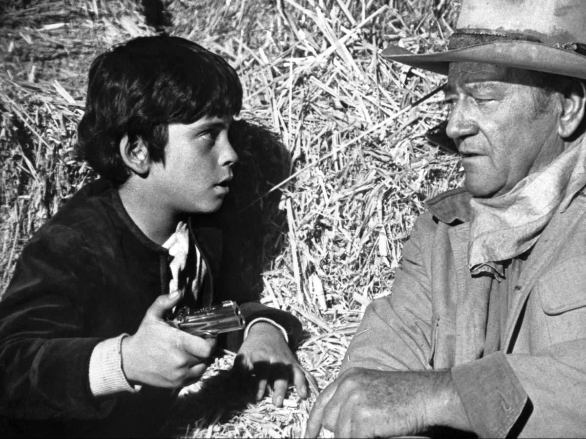 Ethan and father John Wayne in a still from the 1971 Western Big Jake