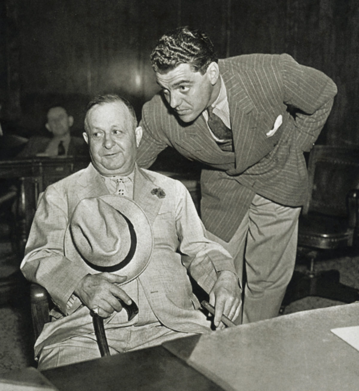 Bernstein, seated, in a New York court in 1938 with lawyer Greg Bautzer to answer charges of kiting checks.