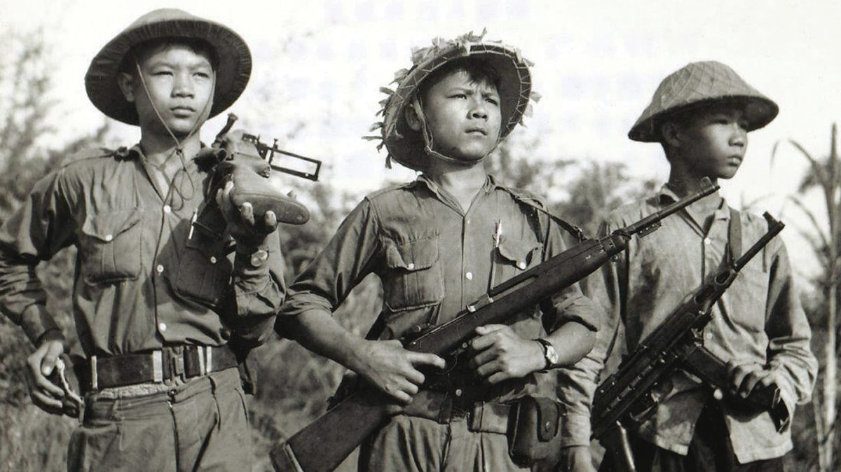 Photo of Soldiers of the National Liberation Front , the Viet Cong, in the early 1960s display weapons from a variety of sources, from left, a captured American M79 grenade launcher; an American M1 carbine, captured from the French or South Vietnamese or supplied by the Chinese; and a K-50M submachine gun supplied by North Vietnam.