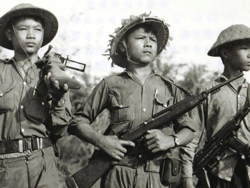Photo of Soldiers of the National Liberation Front , the Viet Cong, in the early 1960s display weapons from a variety of sources, from left, a captured American M79 grenade launcher; an American M1 carbine, captured from the French or South Vietnamese or supplied by the Chinese; and a K-50M submachine gun supplied by North Vietnam.