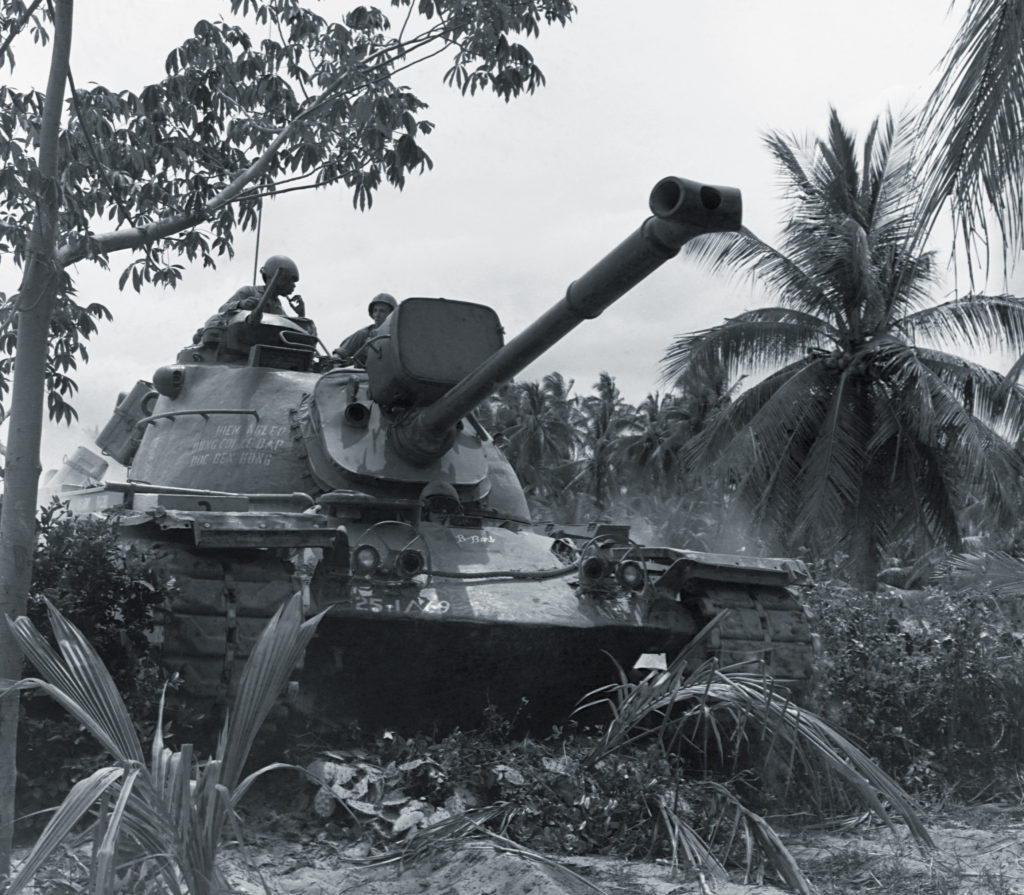 An M48A3 Patton advances through a Vietnamese forest