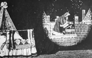 Santa prepares to descend a chimney in this still from Santa Claus (1898).
