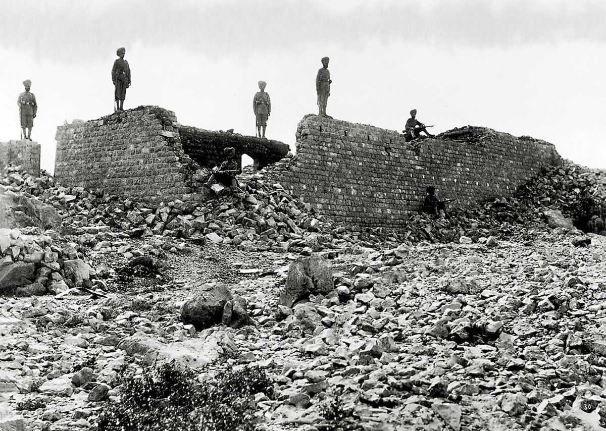 Photo of Sikh soldiers of the British Indian army pose amid the charred ruins of the Saragarhi heliograph station.