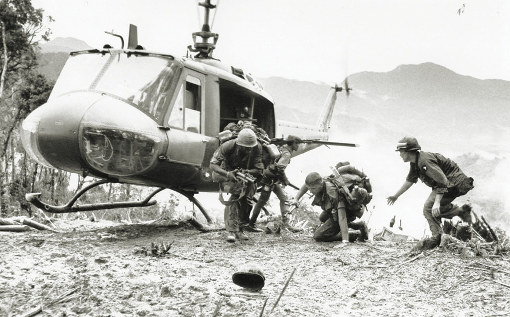 Photo of U.S. paratroopers come to the aid of a fallen buddy after being evacuated from Hamburger Hill on the western edge of the A Shau Valley, May 1969. Troops of the 101st Airborne suffered heavy casualties in 10 days of close quarters fighting before finally taking Ap Bia Mountain.