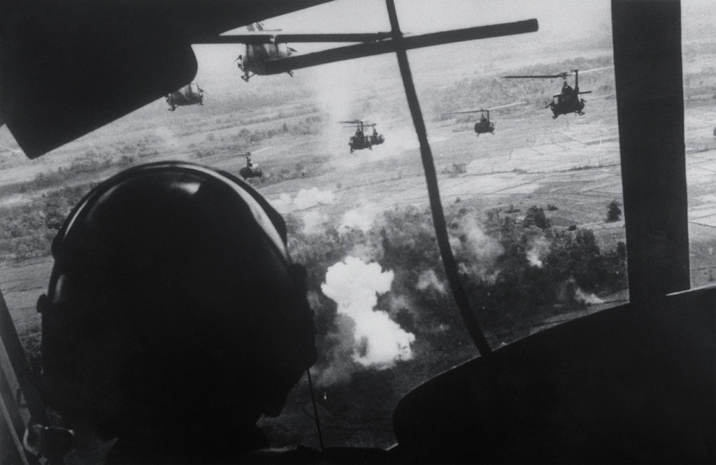 Photo showing, September 18, 1965 - Bien Hoa, South Vietnam: Helicopters, carrying members of the U.S. 173rd Airborne Brigade, fire on a Viet Cong position as they prepare to land about eight miles from Bien Hoa. This was the Brigade's first jungle operation since its arrival in South Vietnam.