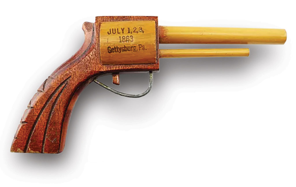 Photo of a 1920s wooden pistol stamped with battle dates doubled as both a souvenir and a toy for a lucky young visitor.