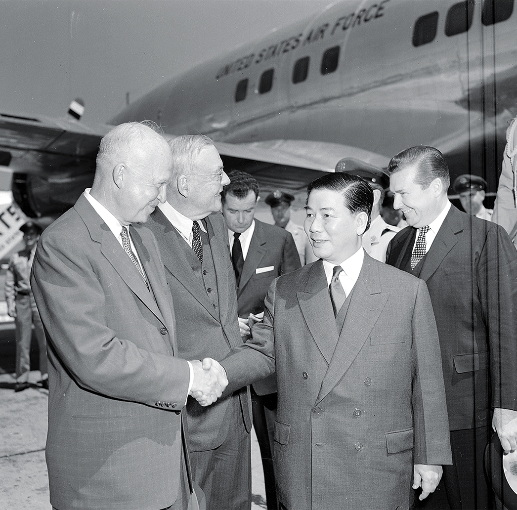Photo of U.S. President Dwight D. Eisenhower and Secretary of State John Foster Dulles (from left) greet South Vietnamese President Ngo Dinh Diem at Washington National Airport.