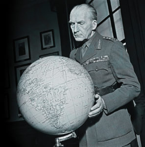 Photo of British Army officer General Sir John Greer Dill (1881-1944), Chief of the Imperial General Staff, studies a globe in his office in London during World War II in January 1941.
