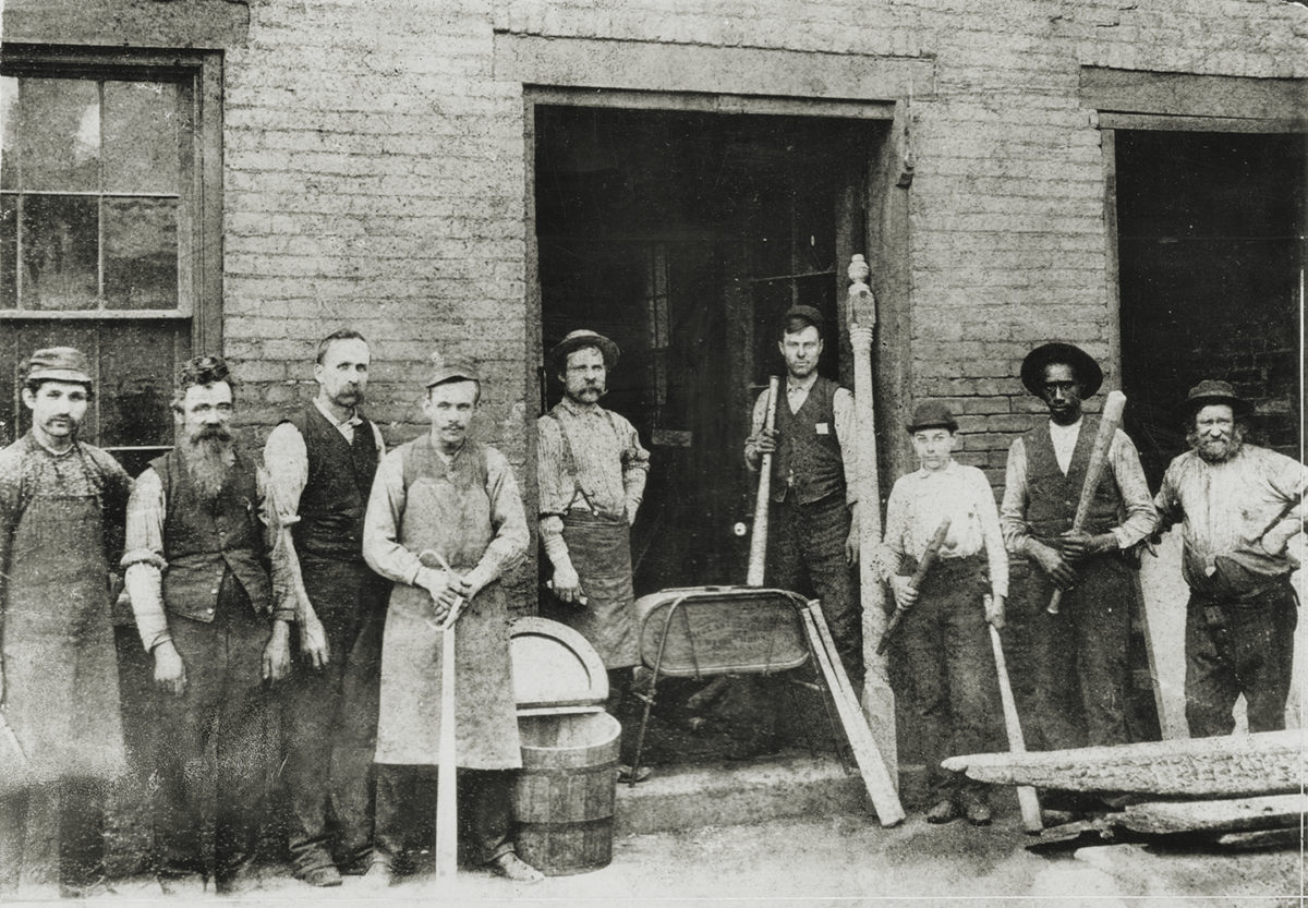 Photo of workers at the Louisville Slugger Factory.