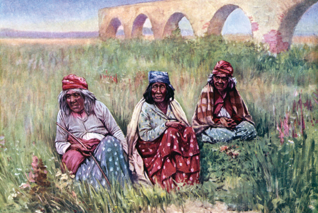 Mission Indian women seated in grass