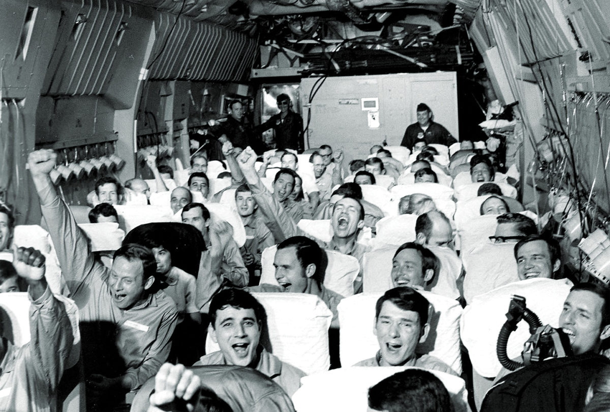 Photo of American servicemen, former prisoners of war, are cheering as their aircraft takes off from an airfield near Hanoi as part of Operation Homecoming.